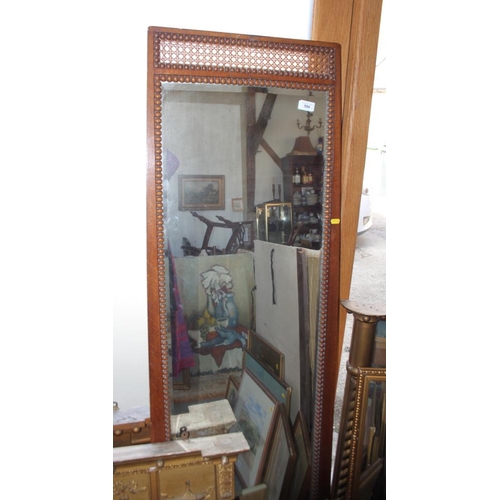 594 - A mahogany framed full length dressing mirror, decorated caned panels and carved pendants, label ver... 