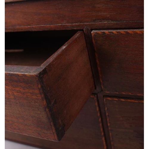 157 - A 19th century mahogany miniature chest of four drawers with hinged top inlaid vase, 17