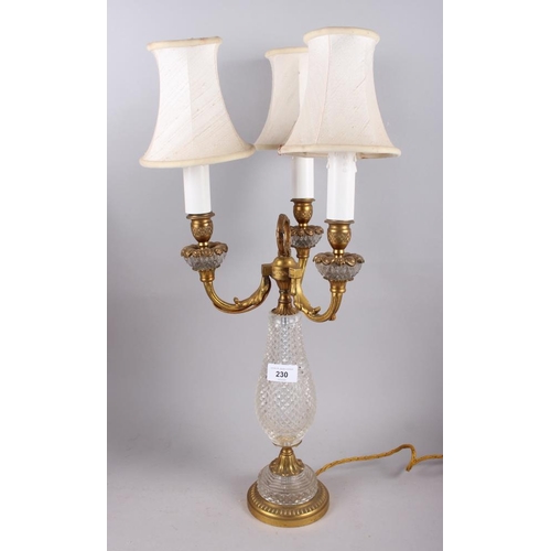 230 - A gilt metal three-light candelabrum with cut glass body fitted electric light