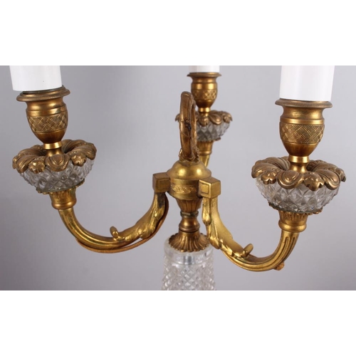 230 - A gilt metal three-light candelabrum with cut glass body fitted electric light