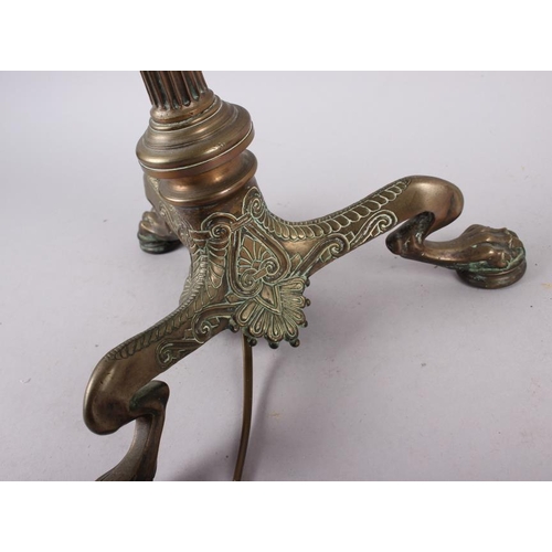 234 - A brass table lamp with reeded column, on three claw feet, 19