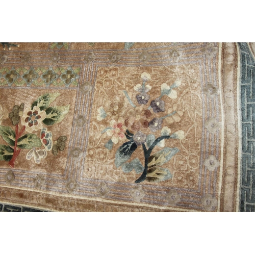 736 - A Chinese silk carpet decorated thirteen floral panels on a beige ground and main floral border stri... 