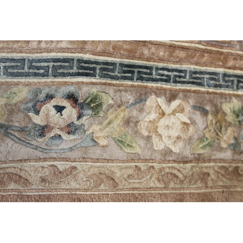 736 - A Chinese silk carpet decorated thirteen floral panels on a beige ground and main floral border stri... 