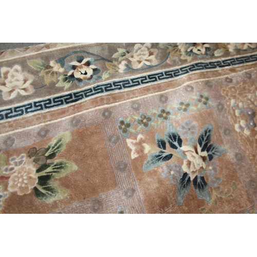 736 - A Chinese silk carpet decorated thirteen floral panels on a beige ground and main floral border stri... 