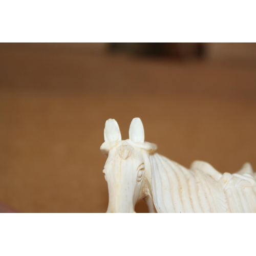 97 - A number of carved ivory Emperor's horses, one on hardwood stand