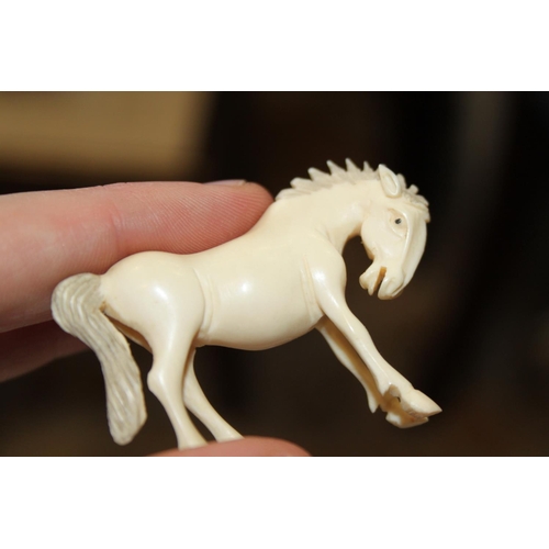 97 - A number of carved ivory Emperor's horses, one on hardwood stand