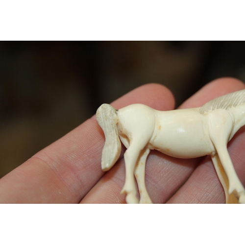 97 - A number of carved ivory Emperor's horses, one on hardwood stand