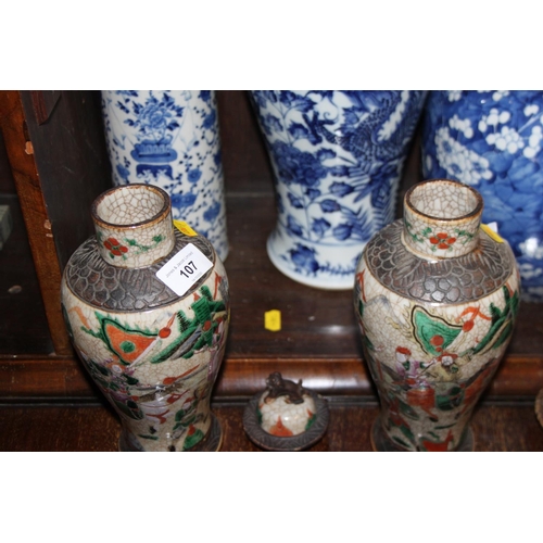 107 - A pair of Canton enamel vases, decorated warriors, 10