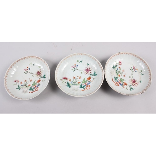 114 - A set of four Chinese tea bowls with floral and scroll decoration, and three matching dishes (chips ... 