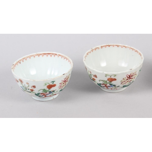 114 - A set of four Chinese tea bowls with floral and scroll decoration, and three matching dishes (chips ... 