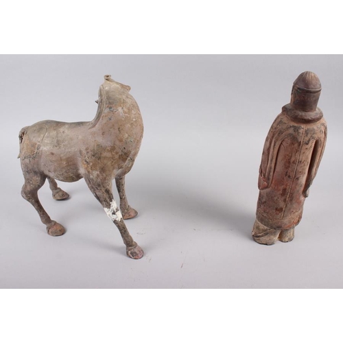 119 - A Tang style horse and a terracotta figure of a soldier, 11 1/2