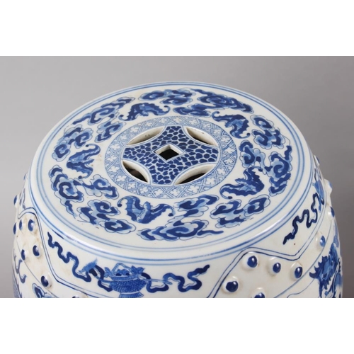 122 - A pair of Chinese blue and white miniature garden seats, decorated dragons and clouds, on hardwood s... 