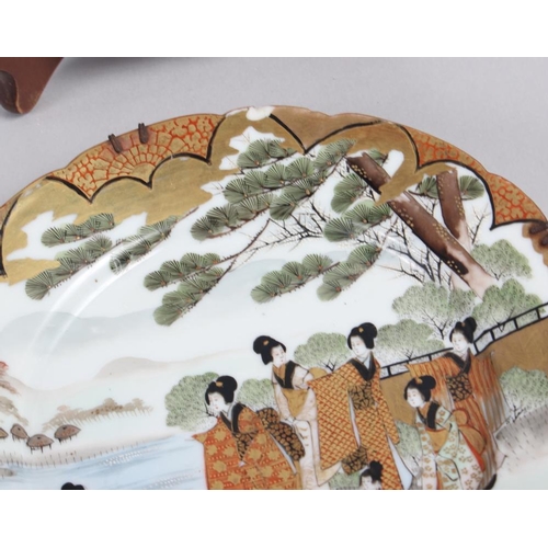 124 - A pair of Chinese plates, decorated monkeys in a landscape with character marks to base, 10 1/4