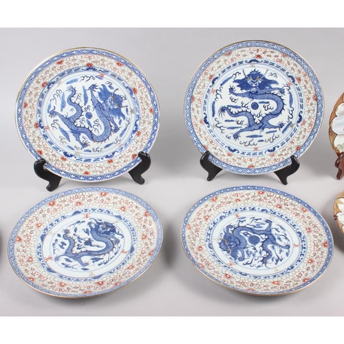 124 - A pair of Chinese plates, decorated monkeys in a landscape with character marks to base, 10 1/4