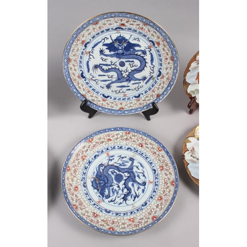 124 - A pair of Chinese plates, decorated monkeys in a landscape with character marks to base, 10 1/4