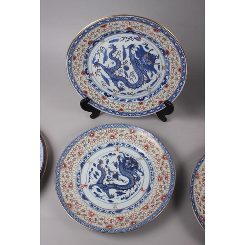 124 - A pair of Chinese plates, decorated monkeys in a landscape with character marks to base, 10 1/4