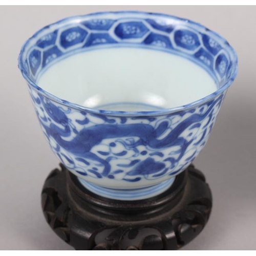 126 - A pair of Chinese blue and white tea bowls, decorated dragons and phoenix with four character marks ... 