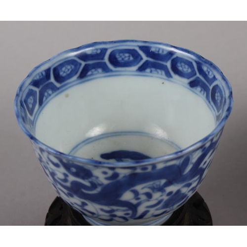 126 - A pair of Chinese blue and white tea bowls, decorated dragons and phoenix with four character marks ... 