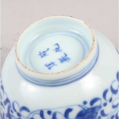 126 - A pair of Chinese blue and white tea bowls, decorated dragons and phoenix with four character marks ... 