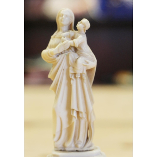 141 - A 19th century Dieppe ivory of the Madonna and child, on circular column and square base, 6