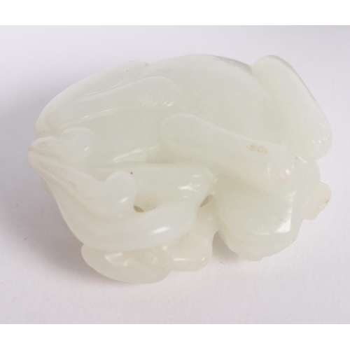 150 - A Chinese celadon jade carving of a recumbent Kylin and clouds, 1 1/2