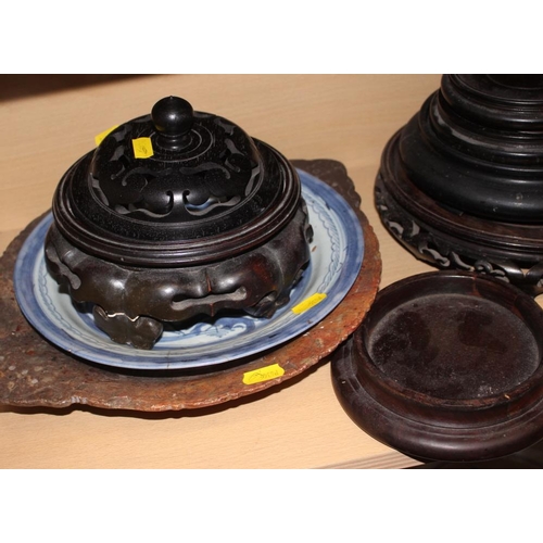 158 - A quantity of hardwood stands and vase covers, a Chinese blue and white dish and a soapstone dish