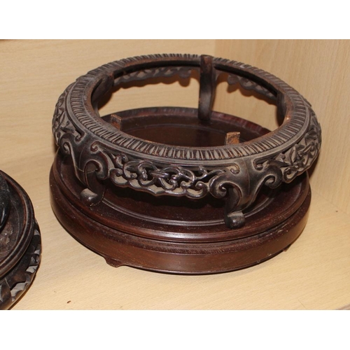 158 - A quantity of hardwood stands and vase covers, a Chinese blue and white dish and a soapstone dish