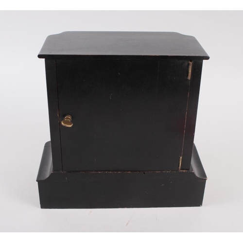 185 - A mahogany and ebonised cased mantel clock with white enamel dial and Roman numerals, 8 1/2