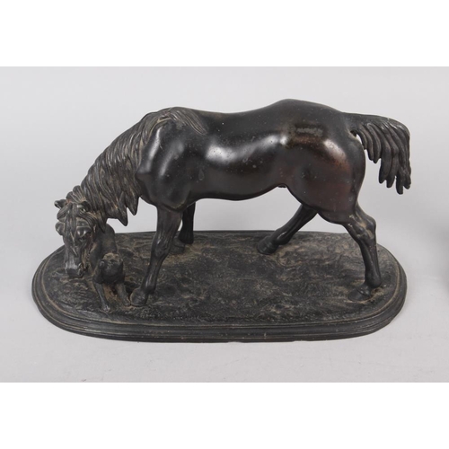 191 - A bronzed model of a horse with a dog, on oval base, 8