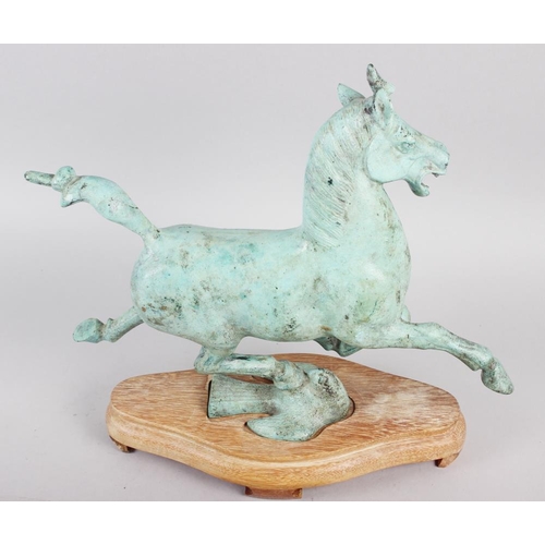 192 - A patinated bronze model of the flying horse of Kansu, on hardwood stand, 10 1/2