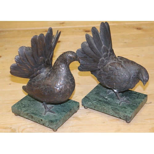 193 - A pair of bronze model pigeons, on green marble bases, 9 1/2