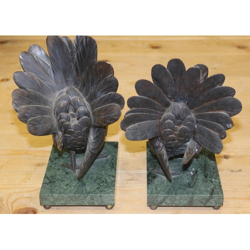 193 - A pair of bronze model pigeons, on green marble bases, 9 1/2