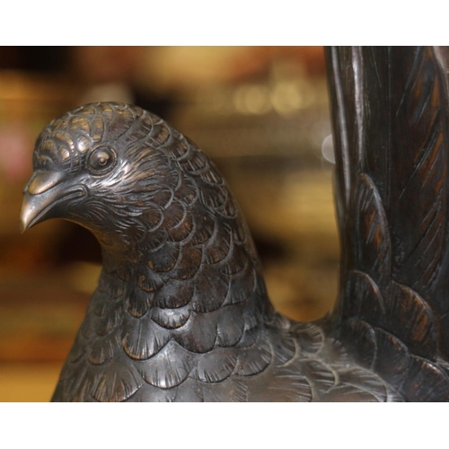 193 - A pair of bronze model pigeons, on green marble bases, 9 1/2