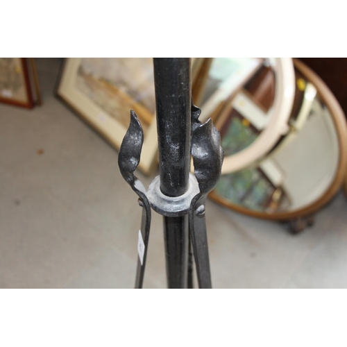 202 - An Edwardian brass oil lamp, on black metal stand with tripod base, 60