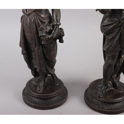 205 - A pair of spelter figure candlesticks, Middle Eastern/Nubian figures carrying oil jars, 14 1/2