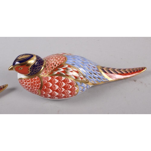 21 - A pair of Royal Crown Derby paperweights, modelled as pheasants, gold stoppers, a similar paperweigh... 