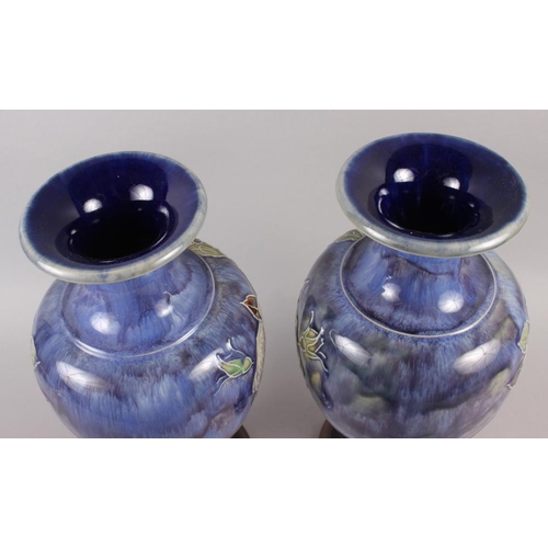 22 - A pair of Royal Doulton blue glazed vases with flared tops and ovoid bodies, tub lined decoration of... 