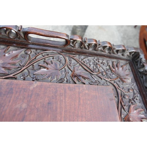 221 - A butler's Far Eastern carved hardwood tray, 29 1/2