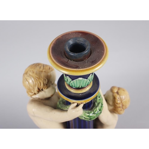 26 - A Minton majolica candlestick with amorini, 12 1/2