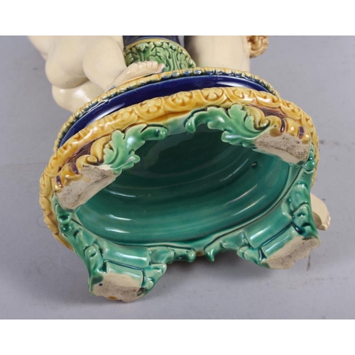 26 - A Minton majolica candlestick with amorini, 12 1/2