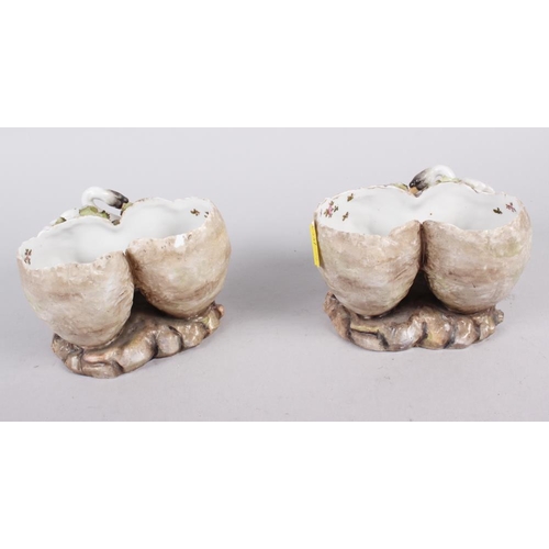 31 - A pair of continental porcelain spill vases, formed as swans with cherubs, 3 1/2