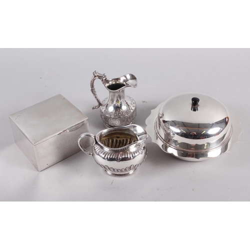 322 - A silver plated muffin dish and cover, two plated jugs and a white metal cigarette box with cedar li... 