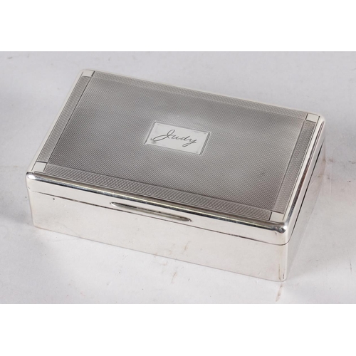 325 - A rectangular engine turned silver table cigarette box, lid engraved 