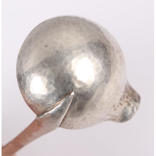 330 - A Danish white metal sauce ladle with all-over planished decoration and amber cabochon to the finial