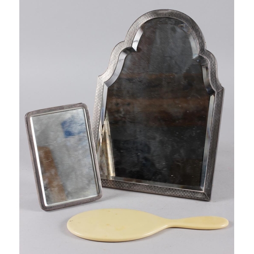 337 - An engine turned silver framed easel mirror with shaped bevelled plate, 12