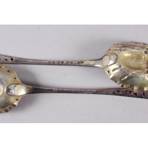 341 - A pair of Georgian silver bottom marked serving spoons with later pierced, engraved and embossed bee... 