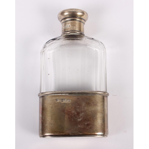 347 - A cut glass spirit flask with silver removable cup and silver lid