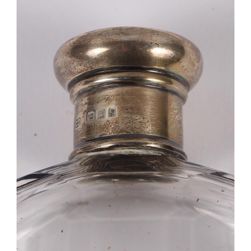 347 - A cut glass spirit flask with silver removable cup and silver lid