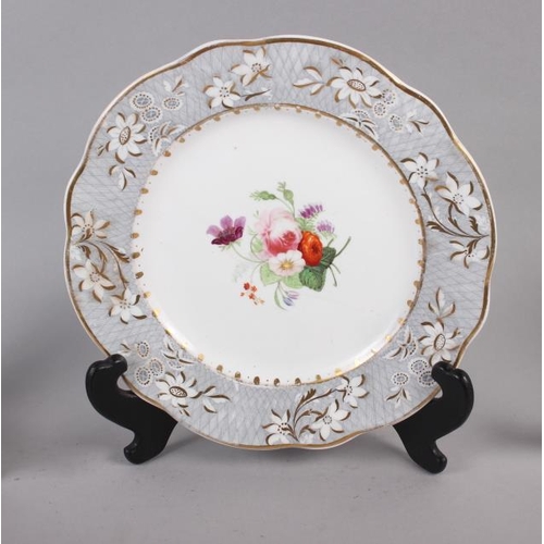 4 - A pair of Rockingham porcelain dessert plates with grey and gilt decorated floral borders and centra... 