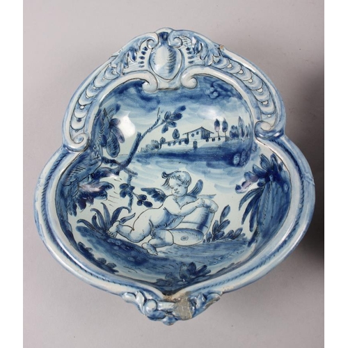 48 - A pair of 19th century Cantagalli blue and white painted dishes with putto decoration (restored)